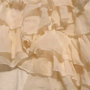 Cream colored sleeveless ruffle sweater top